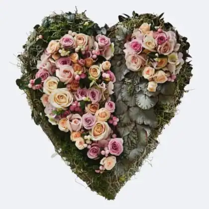 Love Heart Flowers for Funeral: A beautiful arrangement of pink and cream roses on a moss heart wreath.