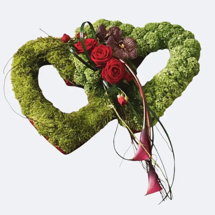 Moss Green and Red Rose Entwined Hearts Tribute 1 Entwined Heart Funeral Flower: a luxurious moss green heart arrangement with deep red roses for a sympathy tribute.