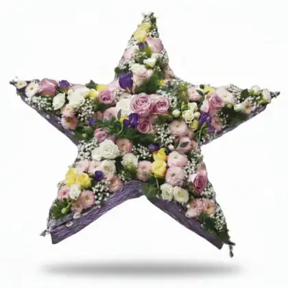 Elegant star funeral flowers arrangement featuring light pink roses, white carnations, and lilac accents, designed as a beautiful sympathy tribute.