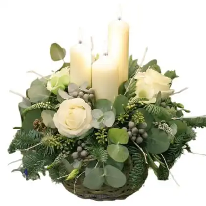 Elegant Christmas White Candle Arrangement featuring tall pillars, silver accents, and winter greenery on a table.