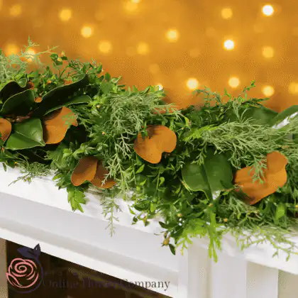 Lush Christmas fern garland with greenery and festive accents for fireplace decoration