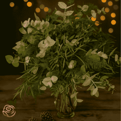 Elegant green cut foliage vases featuring assorted greenery, perfect for Christmas décor and festive table displays