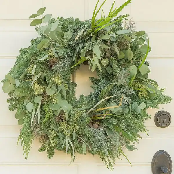 Large Christmas Ramble Wreath 1 A highly detailed, oversized Large Christmas Ramble Wreath featuring a mix of forest greenery, pinecones, and red ribbon, perfect for outdoor display.