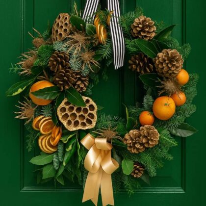 A stylish, minimalist Modern Christmas door wreath with gold hoops and delicate eucalyptus, giving a contemporary holiday look.