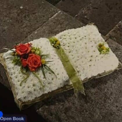 Open Book Funeral Tribute with white flowers and red roses.