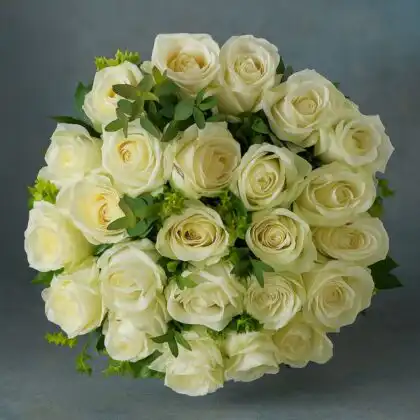 A luxurious, dense round bouquet of pristine white roses with minimal light green foliage on a dark grey background. Flowers for delivery Christmas Eve