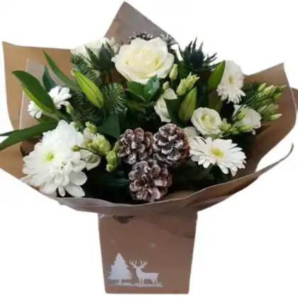 A large luxury Christmas flower bouquet with red roses, orange autumn leaves, red berries, and eucalyptus, presented in a box tied with a rich red velvet bow. Luxury Christmas flower bouquet for sale