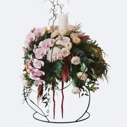 Luxury Candle Floral Arrangement featuring delicate pink orchids, blush roses, and a glowing white candle on a sleek wire stand.