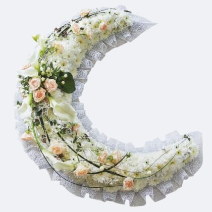 Moon Funeral Flowers tribute featuring soft peach roses and white chrysanthemums in a crescent moon shape.