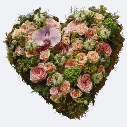 Rose Heart Funeral Flowers - Soft pink and ivory roses arranged in a heart-shaped sympathy tribute resting on a bed of green moss.