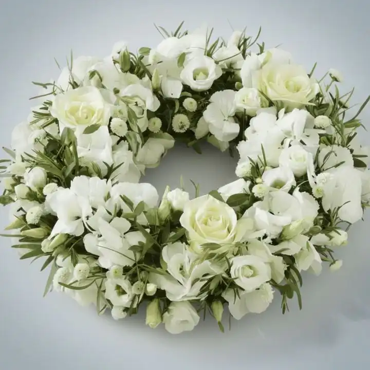 Velvet White Rose Door Wreath 1 A handcrafted white door wreath featuring lush velvet roses and delicate greenery against a neutral background.