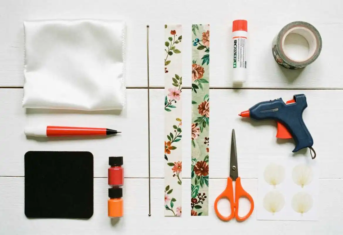 How to Make Artificial Flowers: Easy Step-by-Step Guide 1 Flat lay of artificial flower making supplies including fabric, wire, floral tape, scissors, and crafting tools